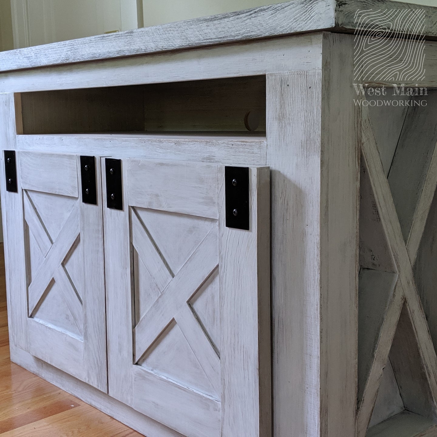 Custom furniture handcrafted farmhouse TV stand finished in cape cod white finish.  The weather white finish and custom faux barn door hardware give it the perfect modern farmhouse touch.  Custom designed and custom built furniture in Groton, MA